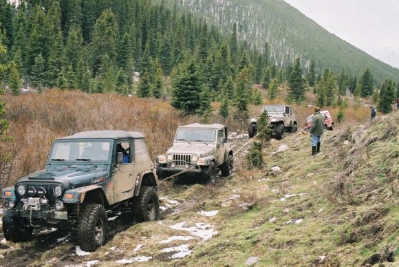 Three Jeeps pulling me out of the mud